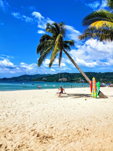 People on beach against sky