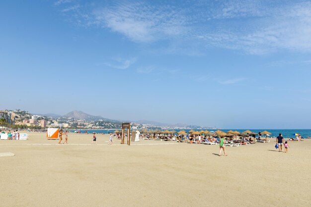 People on beach against sky