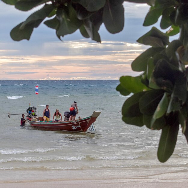 People on beach against sky