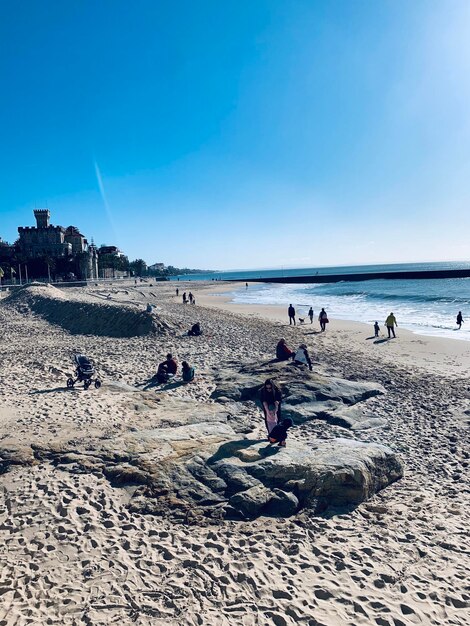 People on beach against sky