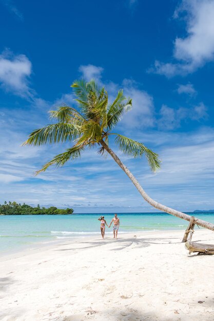 People at beach against sky