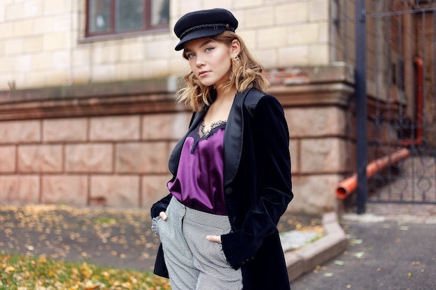 People, beauty, fashion, lifestyle and color concept - Outdoor full body portrait of young beautiful happy smiling girl posing on street. Model looking at camera. Lady wearing stylish clothes