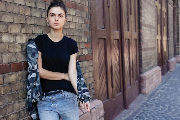 People, beauty, fashion, lifestyle and color concept - Outdoor full body portrait of young beautiful happy smiling girl posing on street. Model looking at camera. Lady wearing stylish clothes