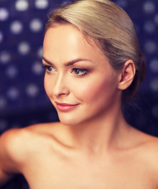 people, beauty, spa, healthy lifestyle and relaxation concept - close up of beautiful young woman sitting in bath towel