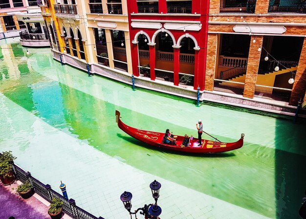 People in boat against building