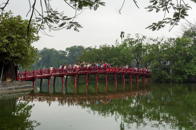 Photo people on bridge over lake against sky