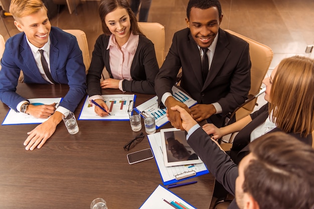 People in business suits at the table discussing cases.