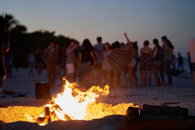 People by bonfire at beach