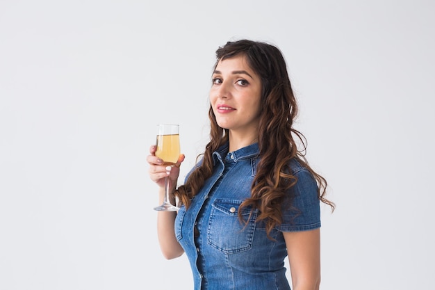 People, celebration and holiday concept - Lovely woman with sparkler and glass of champagne over white background with copy space