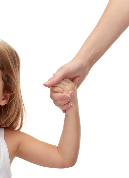 people, charity, family and adoption concept - close up of woman and little girl holding hands