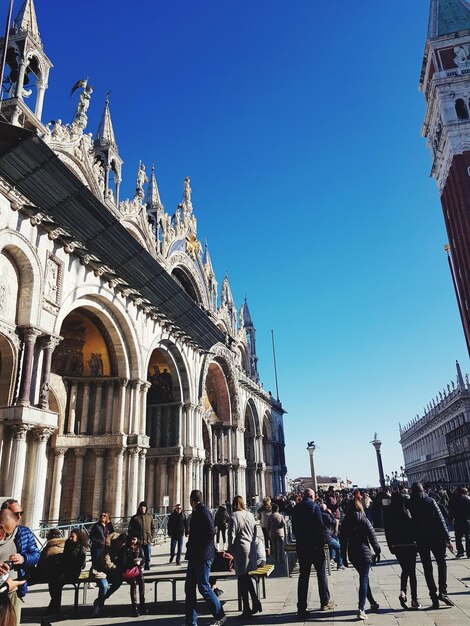 People in city against clear sky