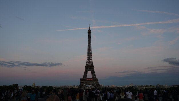 People in city against sky during sunset