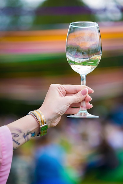 People clinking glasses with wine on the summer terrace of cafe or restaurant