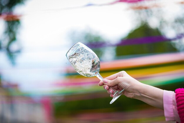 People clinking glasses with wine on the summer terrace of cafe or restaurant