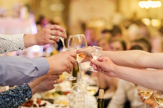 People clinking and toasting glasses of alcohol with each other