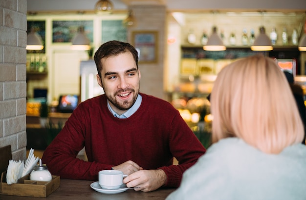 People communication and dating concept young couple drinking tea at cafe