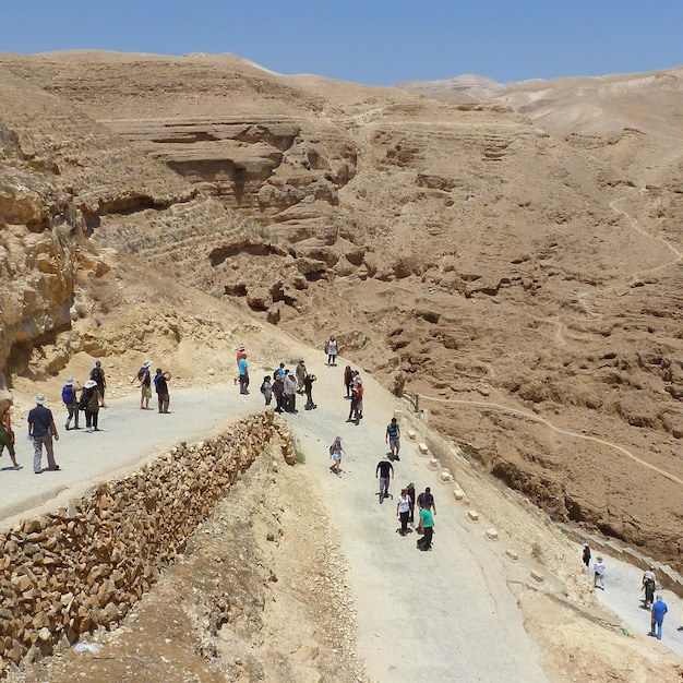 People on desert against sky