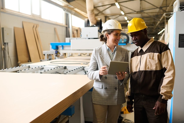 People discussing project at factory