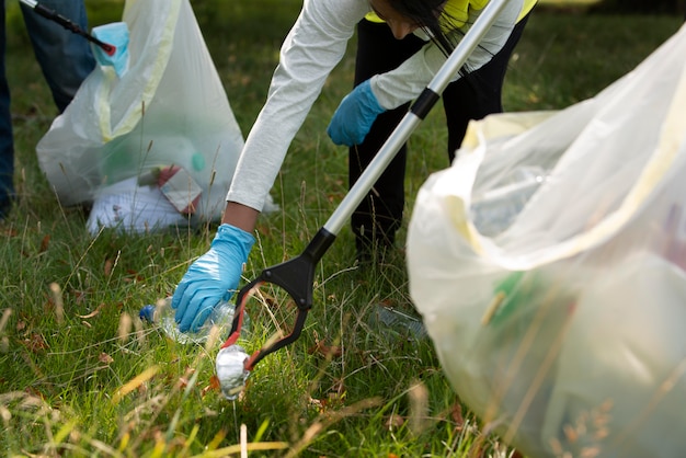 People doing community service by collecting trash in nature