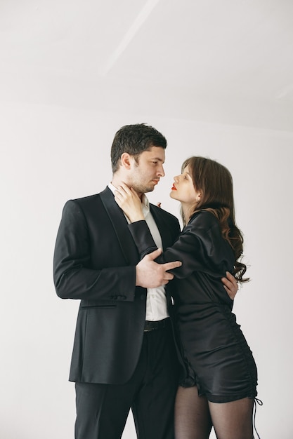 People dressed in classic clothes. Stylish couple in a sensual moment