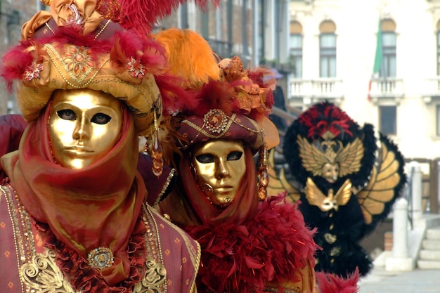 people dressed up for carnival against buildings
