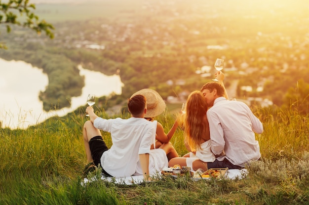 People drink wine and enjoying beautiful landscape.