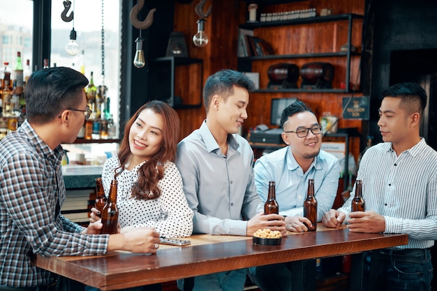 People drinking beer at bar