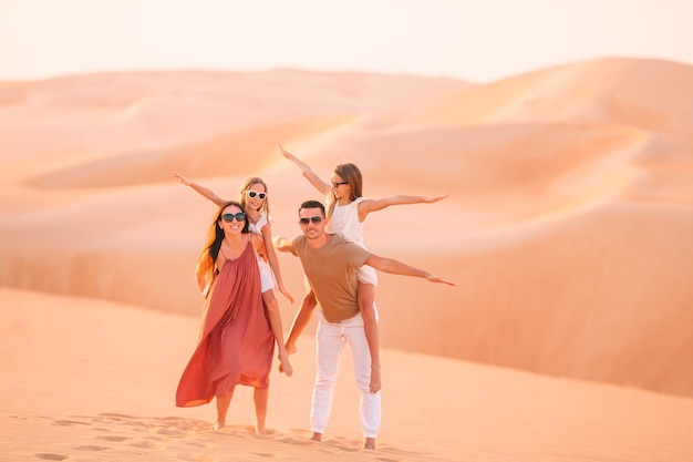 People among dunes in desert in United Arab Emirates