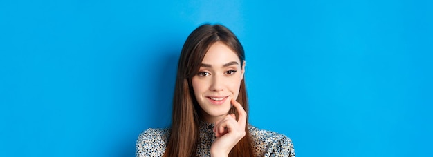 People emotions concept closeup portrait of intrigued pretty lady smiling and looking thoughtful bei