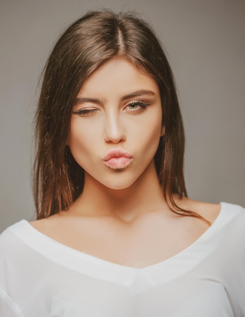 People emotions Happy teen woman winking and kiss Cute girl face portrait