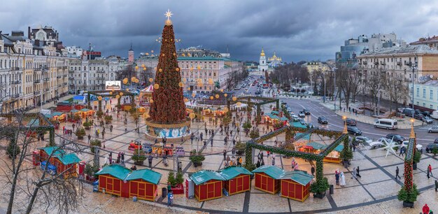 People enjoy the view of the New Year tree on Sophia Square Kyiv Ukraine