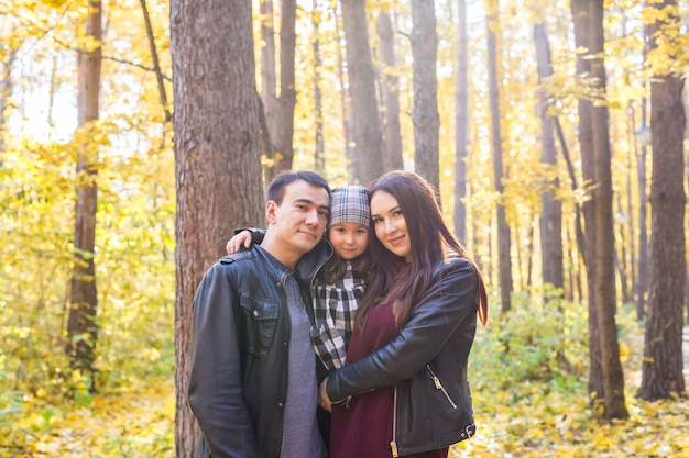 People, family and leisure concept - family having fun standing in autumn park