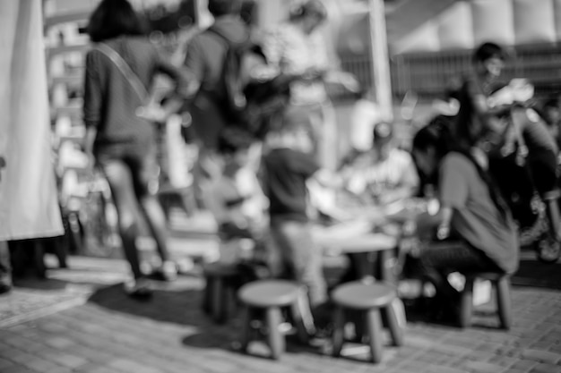 People , Family in a recreation park. Abstract blur people picnic in public park with family or friends, urban leisure lifestyle. Defocused background. Black and white processing