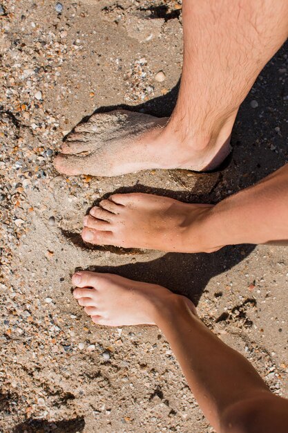 People feet in the sand on the beach