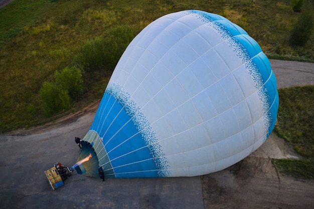 People fill a hot air balloon with warm air before flying