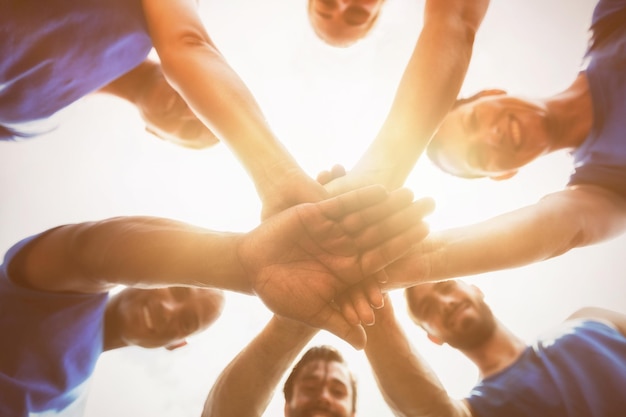 People forming hands stack at camp