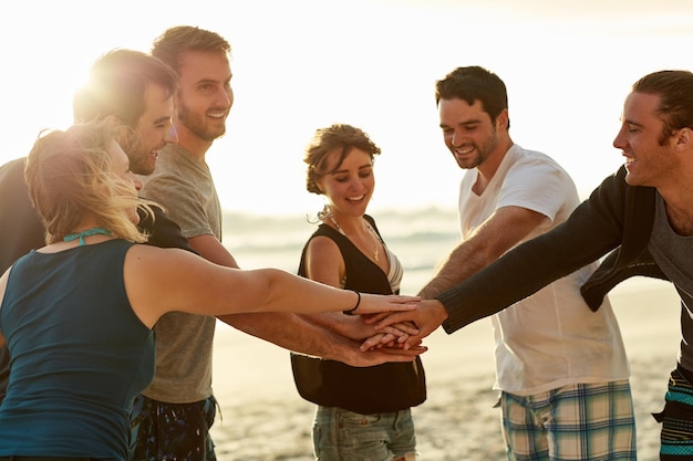 People friends and hands together for team building by beach on travel vacation or break Group relax and solidarity for fun in summer picnic wellness and outdoor adventure at ocean in Greece