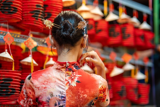 People in front of traditional colorful lanterns hanging on a stand in the streets of Cholon in Ho Chi Minh City Vietnam during Mid Autumn Festival Joyful and happy Selective focus