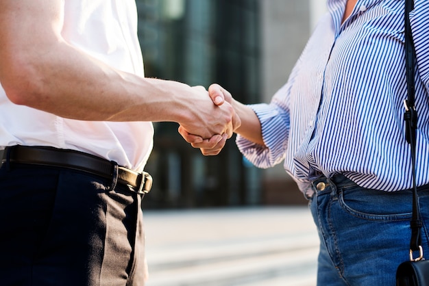 People greeting by shaking hands