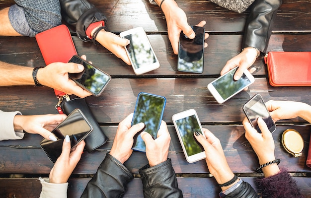 People group having addicted fun together using smartphones