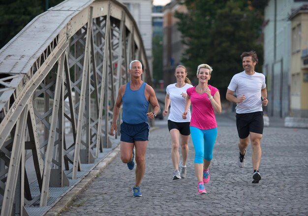 people group jogging  runners team on morning  training workout with sunrise in background