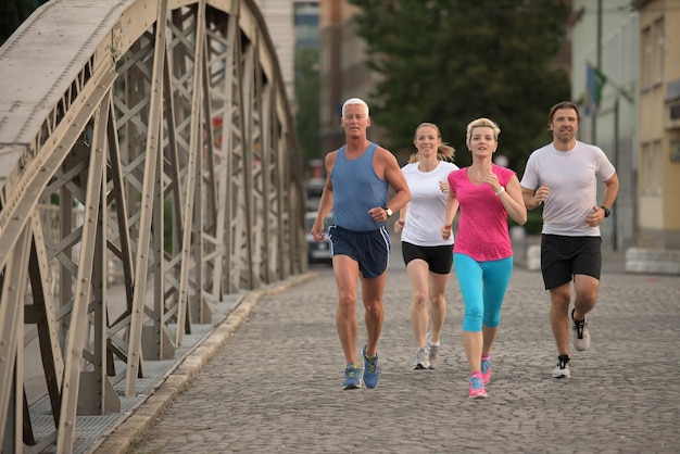 people group jogging  runners team on morning  training workout with sunrise in background