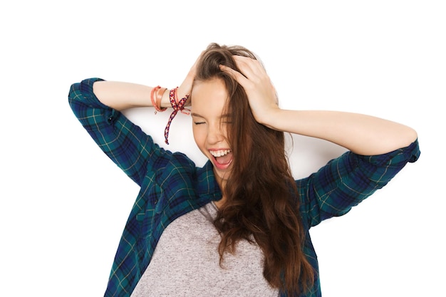 people, hair care, style and teens concept - happy pretty teenage girl holding to head