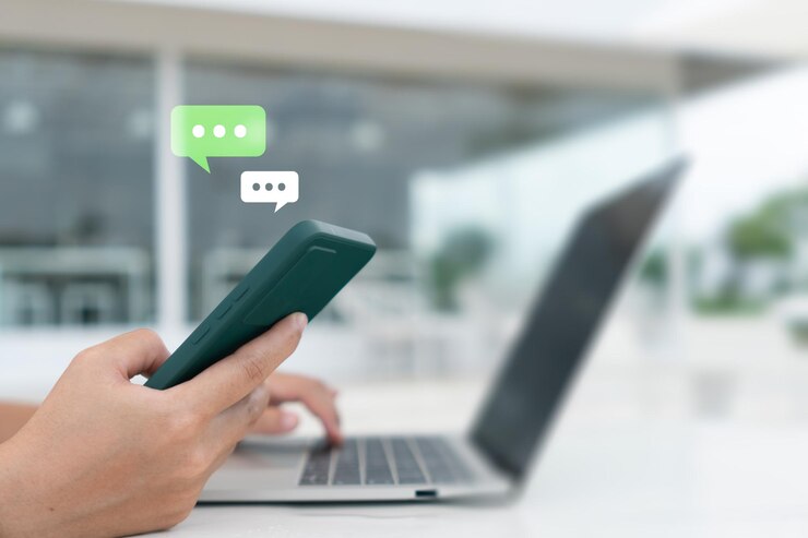 People hand using smartphone typing chatting or text messages in chat icons pop up Social media maketing technology concept