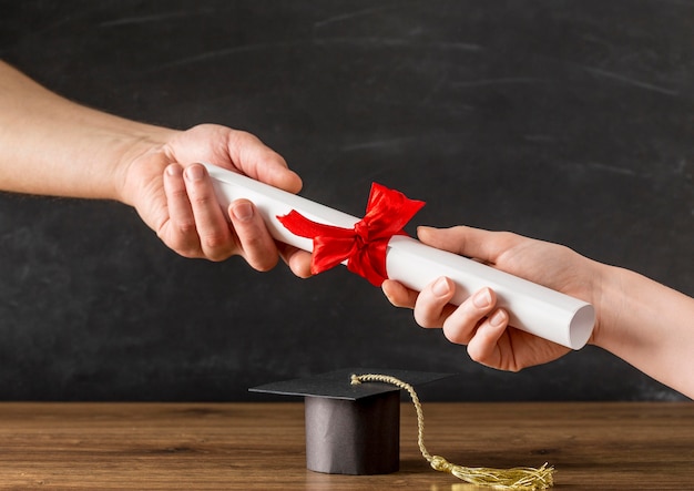 Photo people handing a diploma to each other