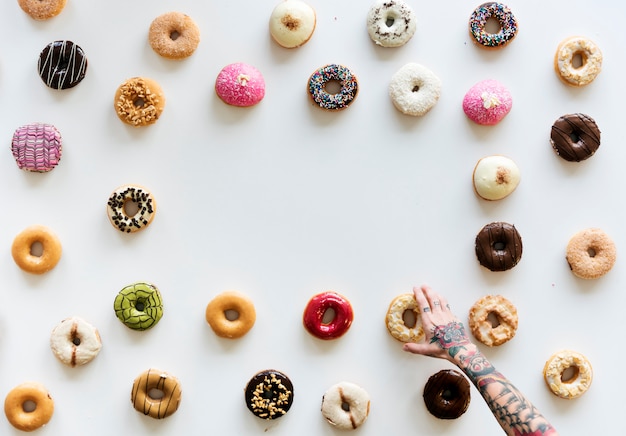 People Hands Reach for Doughnuts