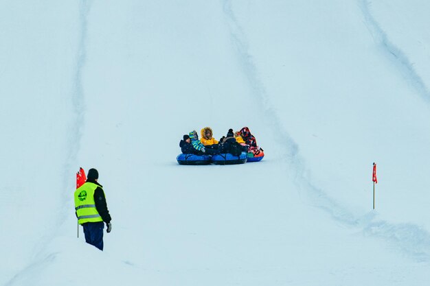 People having fun. snow tubing down by winter hill. winter time