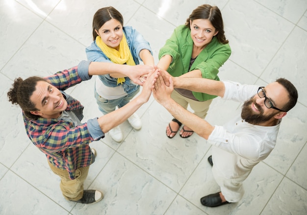 People hold hands together and look up.