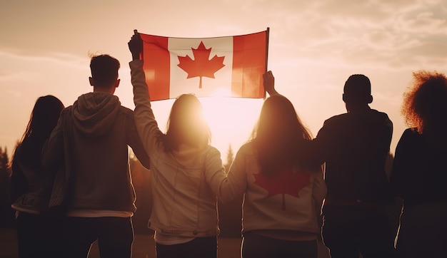 People holding a canadian flag in front of a sunset