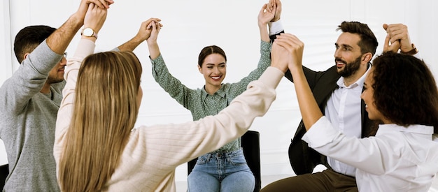 People holding hands at group therapy session indoors Banner design